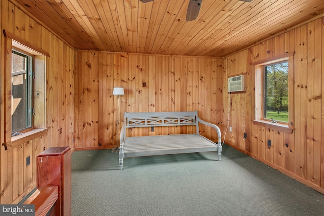 unfurnished bedroom featuring carpet flooring, wood walls, wooden ceiling, and a wall mounted air conditioner