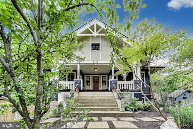 view of front of home featuring stucco siding and a porch
