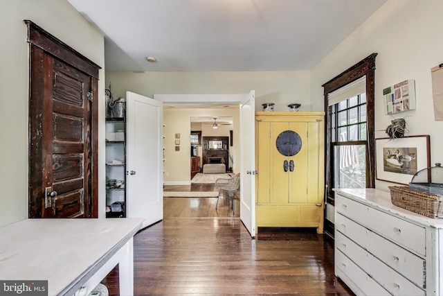 entrance foyer featuring baseboards, dark wood-style flooring, and ceiling fan