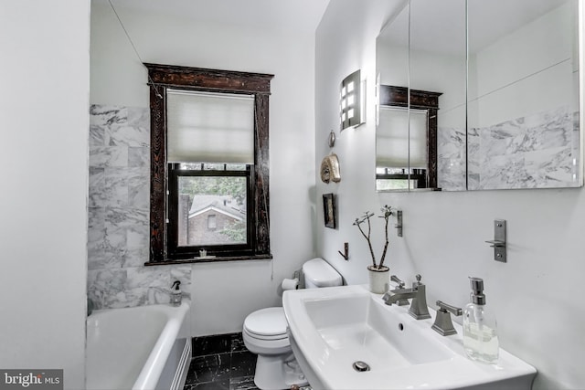 bathroom featuring toilet, a tub to relax in, a sink, and marble finish floor