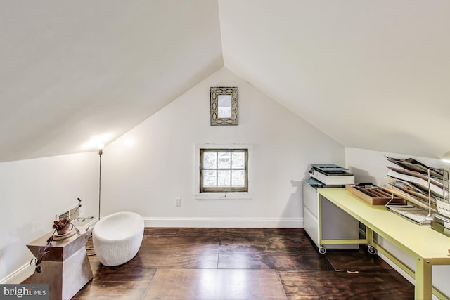 interior space with baseboards, vaulted ceiling, and hardwood / wood-style floors