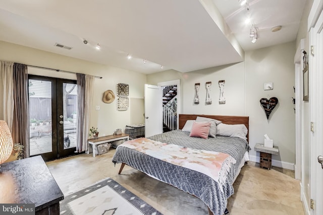 bedroom featuring visible vents, track lighting, access to outside, and french doors