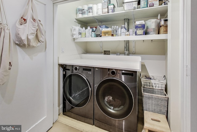 clothes washing area featuring independent washer and dryer and laundry area