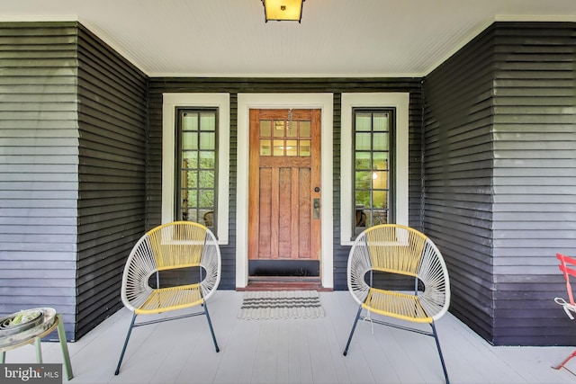 view of exterior entry featuring a porch