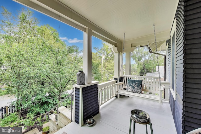 wooden terrace with a porch