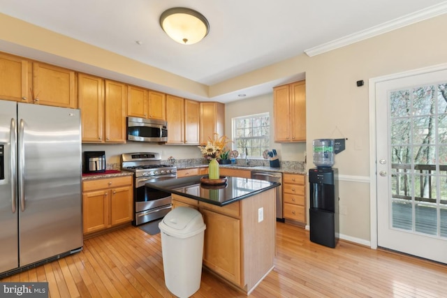 12815 Duck Pond Dr Unit 111, Germantown, MD 20874 - kitchen with stainless steel appliances, a sink, light wood-style flooring, and a center island
