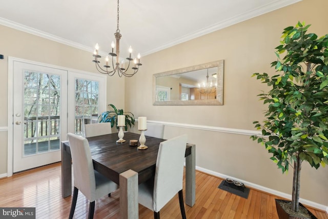 12815 Duck Pond Dr Unit 111, Germantown, MD 20874 - dining room featuring an inviting chandelier, baseboards, crown molding, and hardwood / wood-style floors