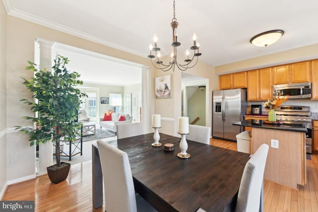 12815 Duck Pond Dr Unit 111, Germantown, MD 20874 - dining room with crown molding, light wood-style flooring, and a chandelier