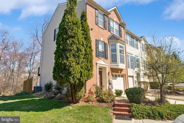12815 Duck Pond Dr Unit 111, Germantown, MD 20874 - townhome / multi-family property featuring brick siding, central AC unit, an attached garage, and a front yard