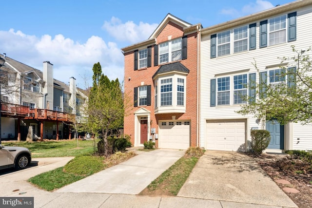 12815 Duck Pond Dr Unit 111, Germantown, MD 20874 - townhome / multi-family property featuring an attached garage, brick siding, driveway, and a residential view