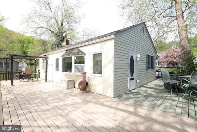 wooden terrace with outdoor dining area