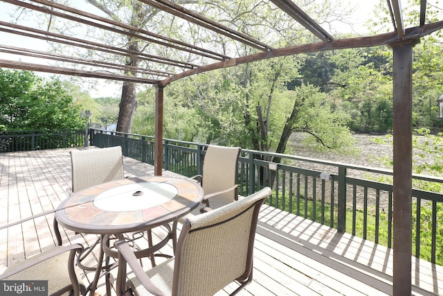 deck with a pergola and outdoor dining space