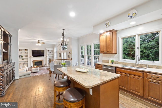 11406 Royal Vw, North Potomac, MD 20878 - kitchen featuring a sink, stainless steel dishwasher, a ceiling fan, a breakfast bar area, and a glass covered fireplace