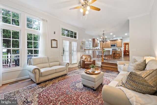 11406 Royal Vw, North Potomac, MD 20878 - living room with light wood-style floors, ornamental molding, a chandelier, a ceiling fan, and baseboards