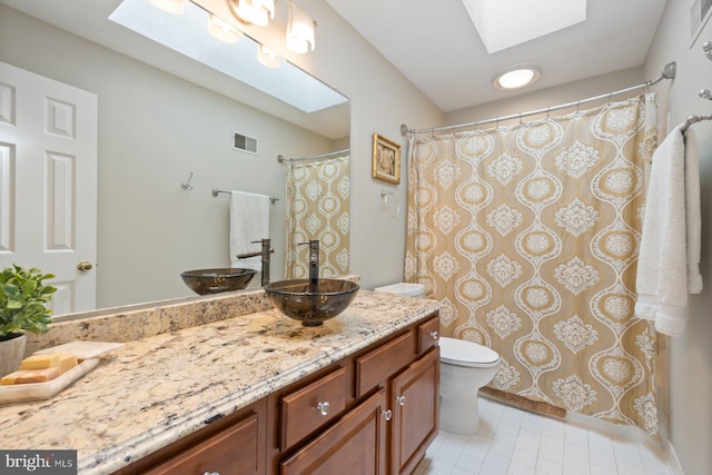 11406 Royal Vw, North Potomac, MD 20878 - bathroom with a skylight, toilet, vanity, tile patterned flooring, and a shower with shower curtain