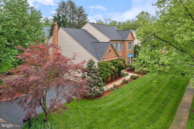 11406 Royal Vw, North Potomac, MD 20878 - view of property exterior featuring a yard, a chimney, and a shingled roof
