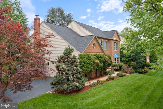 11406 Royal Vw, North Potomac, MD 20878 - view of side of property featuring a lawn, a chimney, a garage, and a shingled roof