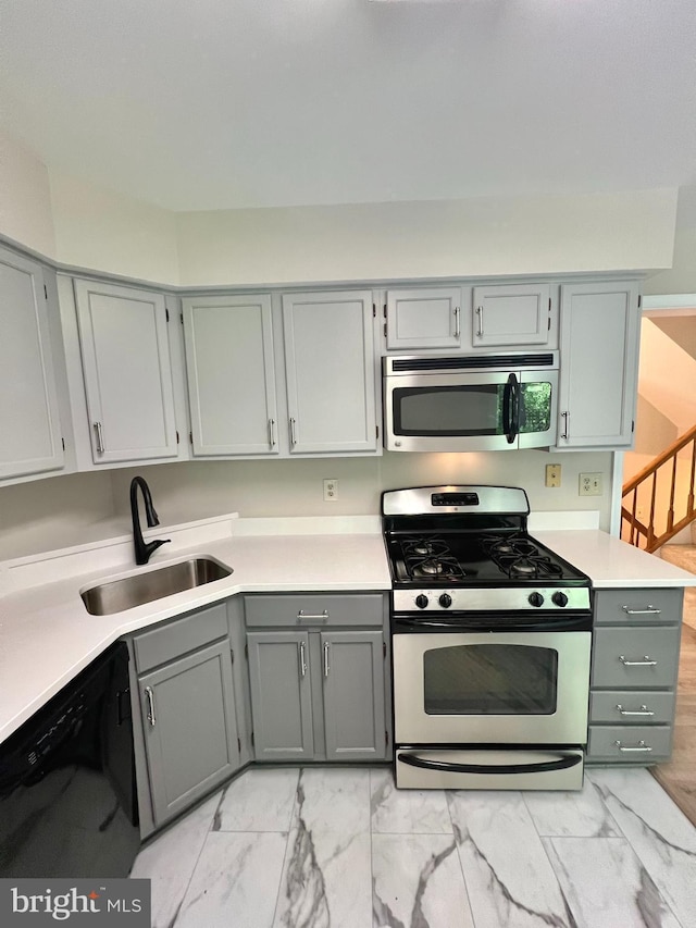 6062 Clay Spur Ct, Centreville, VA 20121 - kitchen featuring stainless steel appliances, a sink, gray cabinetry, and light marble finish floors