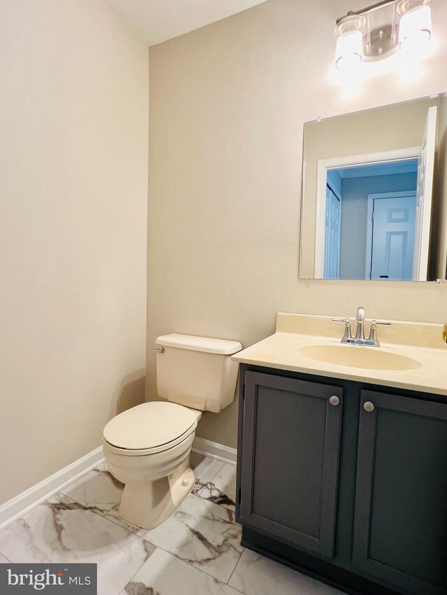 6062 Clay Spur Ct, Centreville, VA 20121 - half bath with marble look tile flooring, toilet, vanity, and baseboards