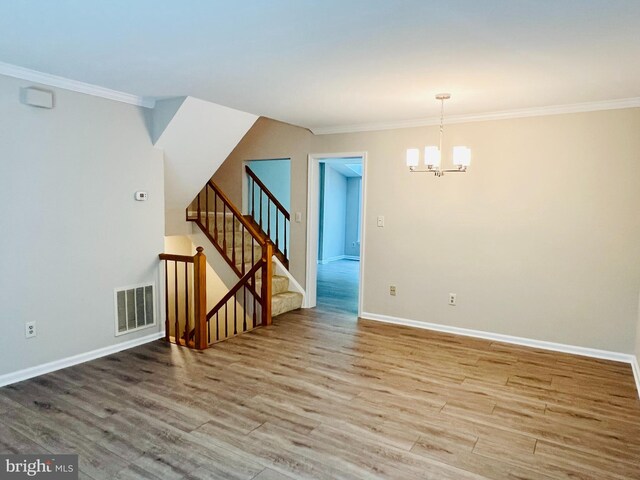 6062 Clay Spur Ct, Centreville, VA 20121 - spare room with crown molding, wood finished floors, a chandelier, baseboards, and stairway