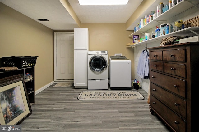 19 Old Hilltop Rd, Conowingo, MD 21918 - clothes washing area featuring independent washer and dryer, visible vents, wood finished floors, and baseboards