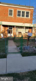 5115 Patrick Henry Dr, Baltimore, MD 21225 - rear view of house with a fenced front yard