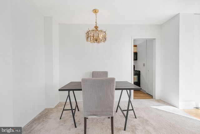 dining area featuring baseboards, carpet, and a chandelier