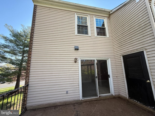 back of house with fence
