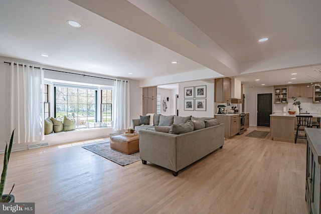 living area featuring recessed lighting, visible vents, and light wood-style flooring
