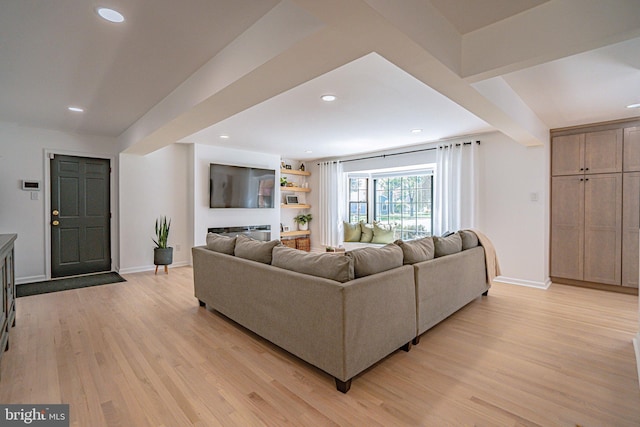 living room with light wood-style floors, baseboards, and recessed lighting