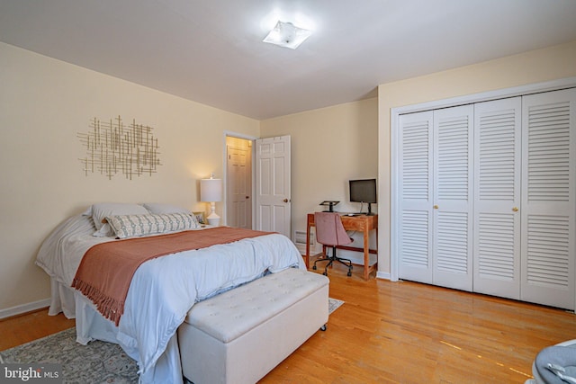 bedroom featuring a closet, baseboards, and light wood-style floors