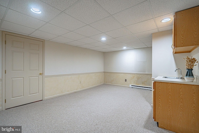 interior space with recessed lighting, a sink, a baseboard heating unit, and carpet flooring