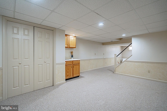 finished basement with recessed lighting, light colored carpet, a drop ceiling, and stairway