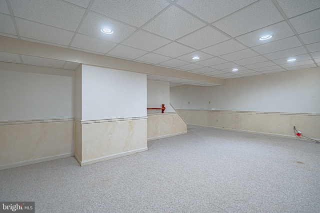 finished below grade area with recessed lighting, carpet flooring, baseboards, and a paneled ceiling