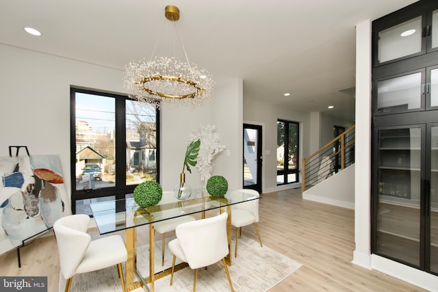 dining room with an inviting chandelier, stairs, recessed lighting, baseboards, and wood finished floors