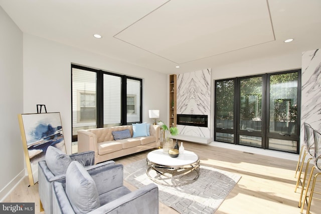 living area with recessed lighting, baseboards, wood finished floors, and attic access