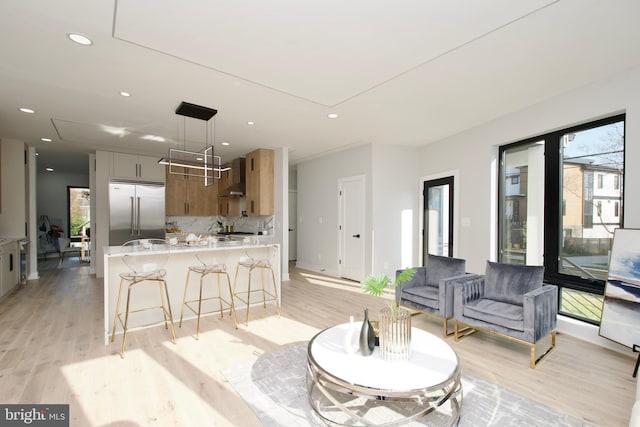 living area featuring recessed lighting, attic access, and light wood-style flooring