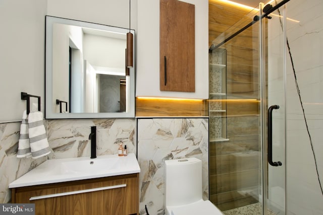 bathroom featuring vanity, toilet, tile walls, decorative backsplash, and a shower stall