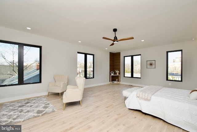 bedroom featuring recessed lighting, multiple windows, and light wood-style floors