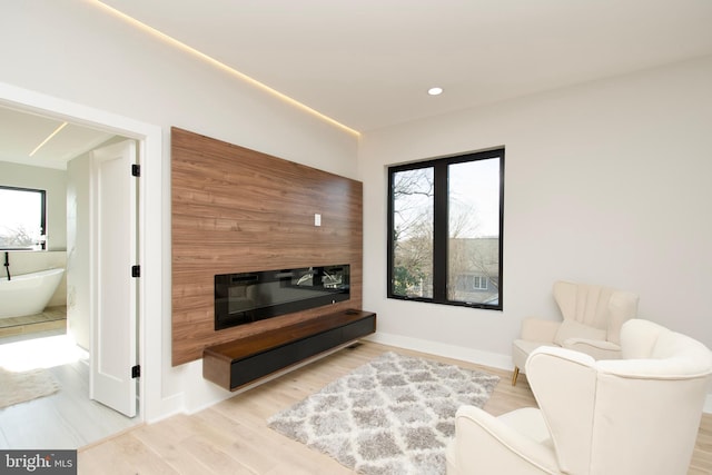 living room with baseboards, recessed lighting, wood finished floors, and a fireplace