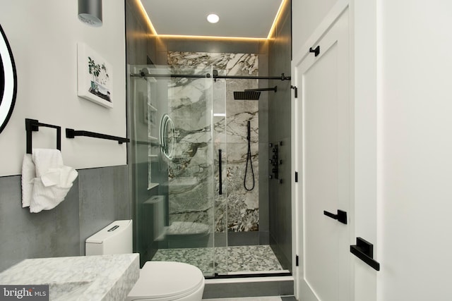 full bath with toilet, recessed lighting, and a marble finish shower