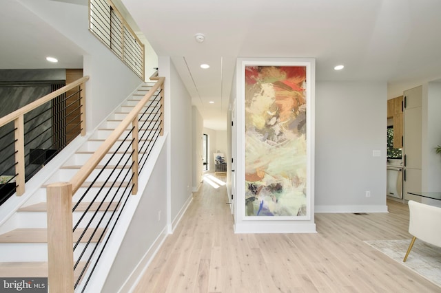 hallway with recessed lighting, baseboards, and wood finished floors