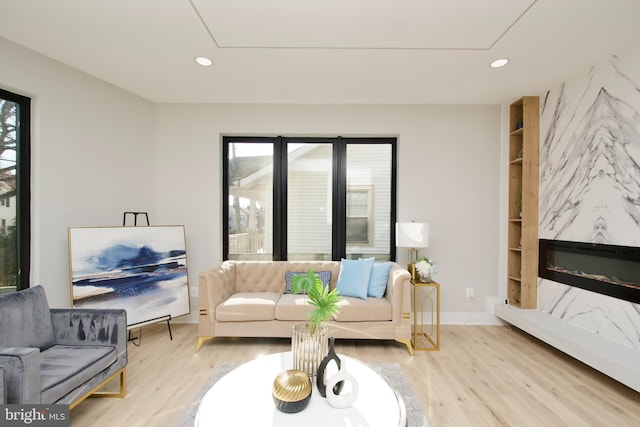 living area featuring recessed lighting, attic access, and light wood finished floors