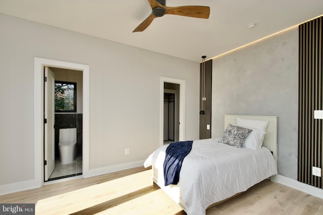 bedroom with light wood-type flooring and baseboards