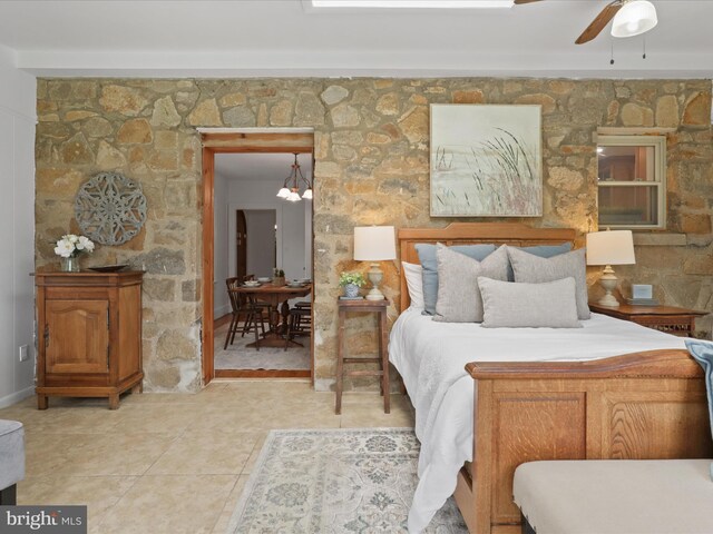 tiled bedroom with a chandelier