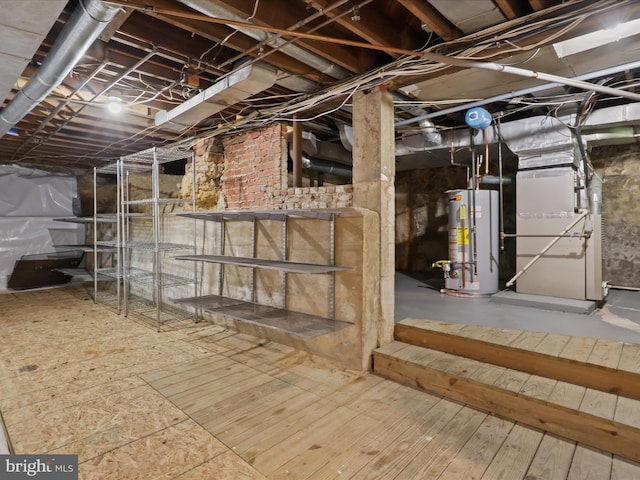 unfinished basement with water heater and heating unit