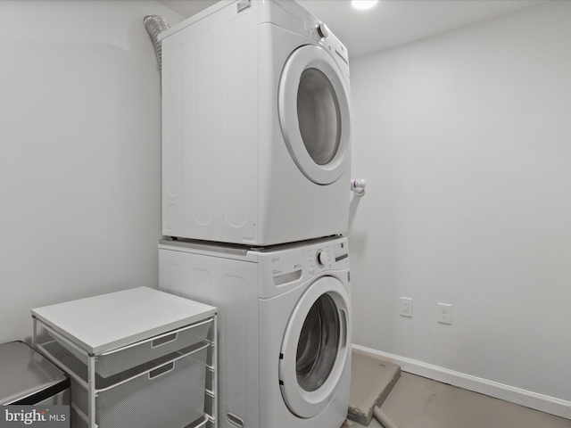 washroom with stacked washing machine and dryer