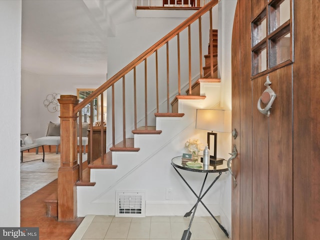 staircase with tile patterned floors