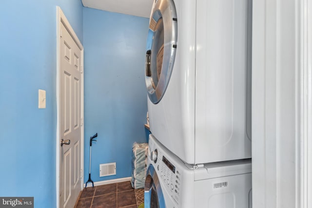 3401 Kidder Rd, Clinton, MD 20735 - washroom with stacked washer and clothes dryer, baseboards, and dark tile patterned floors