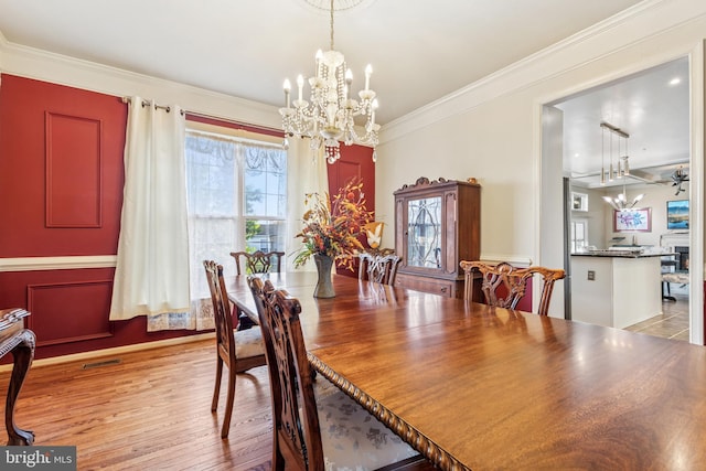 3401 Kidder Rd, Clinton, MD 20735 - dining area featuring a chandelier, crown molding, and light wood-type flooring